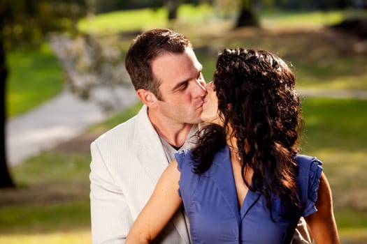 A couple in the park happy and kissing