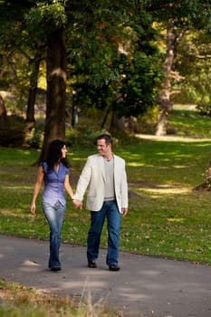 A couple happy and walking in a park