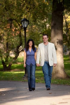 A happy couple walking in the park