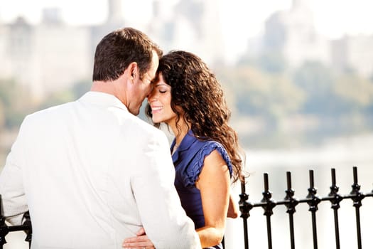 A man and woman in a park hugging