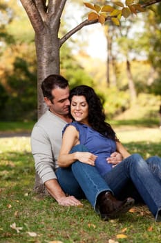 A happy couple in the park relaxing and enjoying eachothers company
