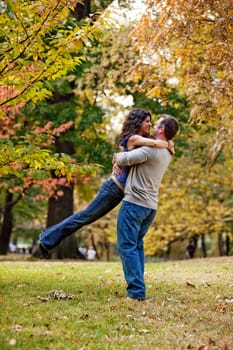 A man and woman hugging in a park