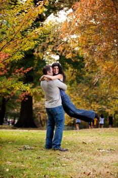 A man giving a bear hug to a woman
