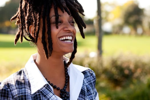 Young woman laughing. Horizontally framed shot.