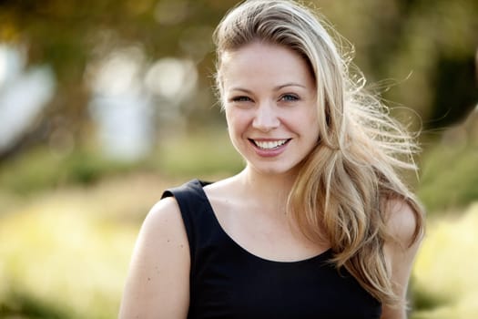 Young adult female model in outdoor setting. Horizontally framed shot.