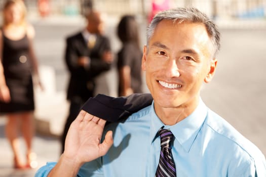 Four business people with middle aged man as focus. Horizontally framed shot.