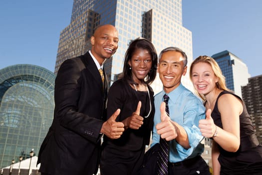 Four business people giving thumbs up. Horizontally framed shot.