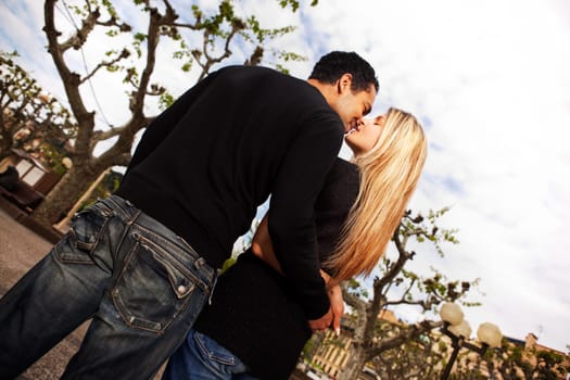 A couple kissing in a urban city park in France