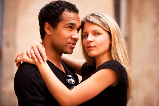 An attractive french couple in an outdoor urban setting