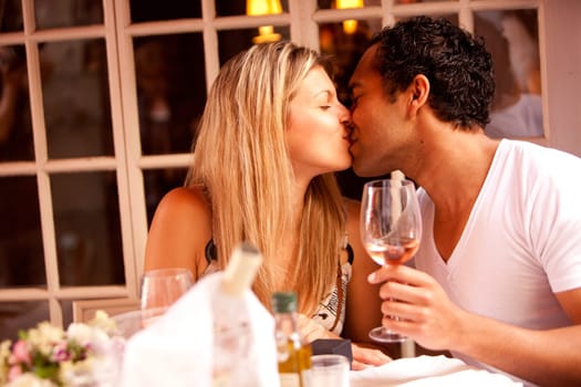 A man and woman having a romantic meal in an outdoor cafe