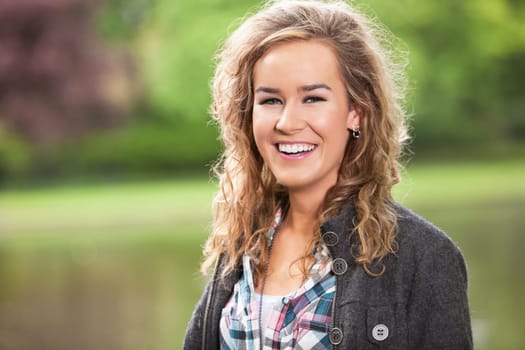Beautiful young woman smiling outdoors in park