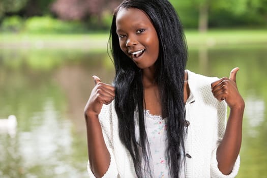 Young African American woman showing you thumbs up