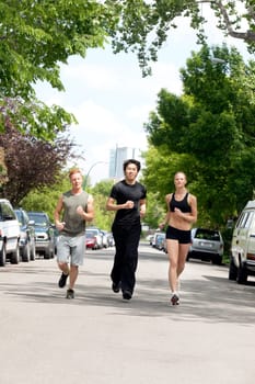 Friends jogging on the street by land vehicle