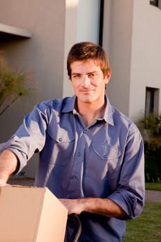 A portrait of a man with moving boxes on a trolly