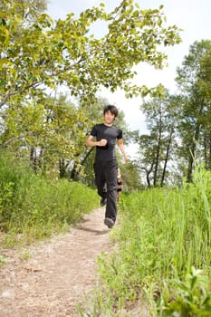 Young man jogging with his friends in the background