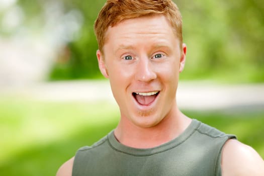 Excited man with mouth open against blur background