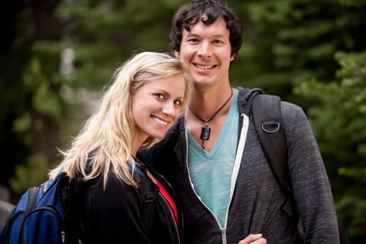 A happy couple hiking in the forest