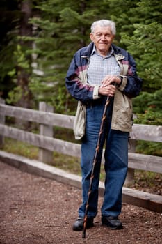 A senior man walking outdoors on a path