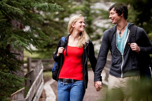A young mand and woman walking in the forest