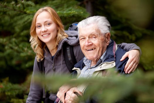 A portrait of a granddaughter and grandfather.  Shallow depth of field, focus on grandfather.