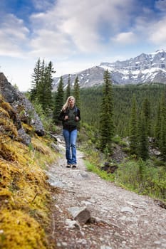 A woman walking on a mountain trail