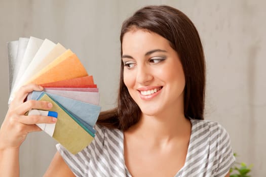A young femail looking at a group of color swatches