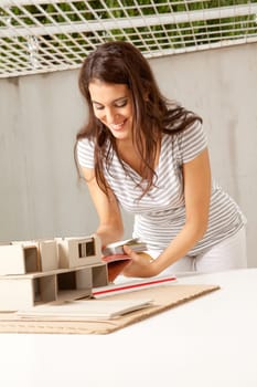 A young female architect choosing color swatches for a building
