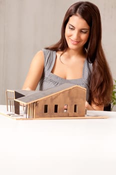 A female architect building a rough house study model