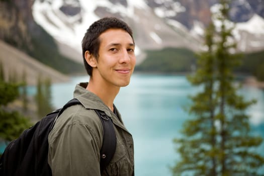 A portrait of a man outdoors on a hiking trip