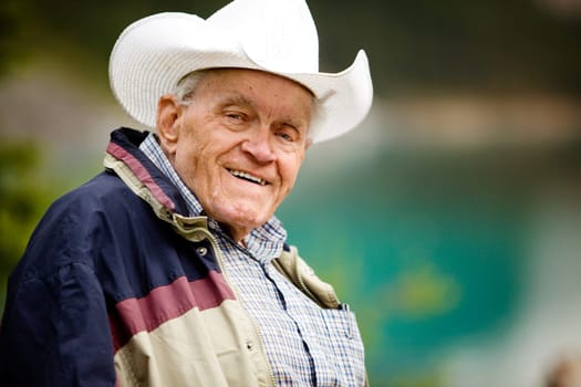 A portrait of a happy elderly man with cowboy hat