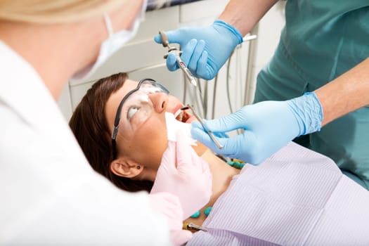 A dentist giving a freezing needle to a worried patient