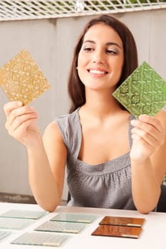 An interior architect / designer choosing a glass tile