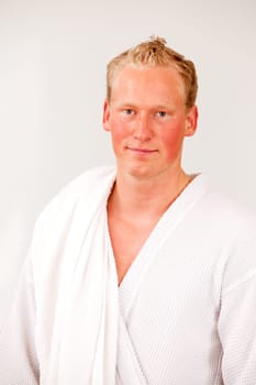 A portrait of a content man wearing a bathrobe