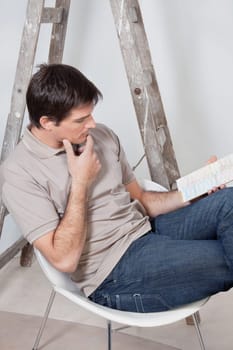Thoughtful man going through the color swatch for his new apartment