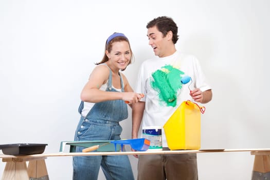 Happy Caucasian woman playing around with color on her boyfriend's shirt