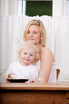 A mother and son looking content at the camera - shallow depth of field critical focus on boy's eyes