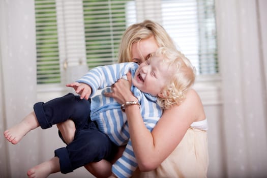 Portrait of a mother and son laughing and joking together