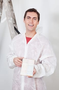 Portrait of a smiling workman showing the color swatch