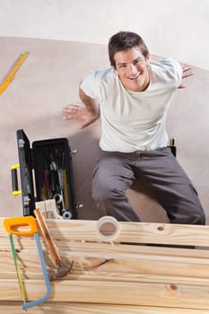 A construction worker with tools and wood
