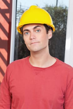 Close-up portrait of young architect wearing hard hat