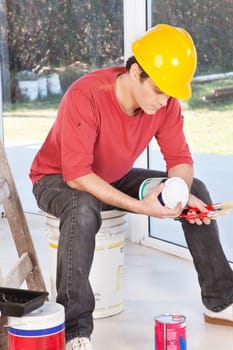 Architect reading instructions on paint box