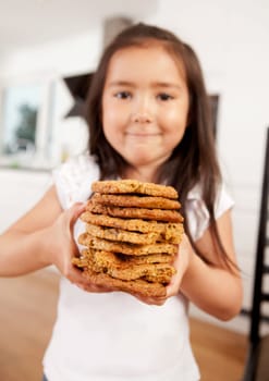 Proud young child with stack of freshly baked cookies - Shallow DOF, focus on cookies