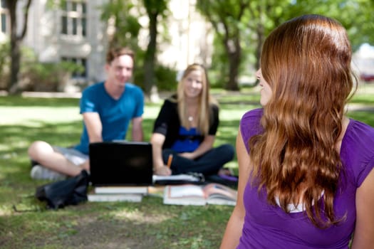 Smiling brunette student looking back at friends