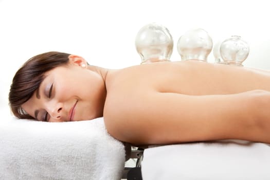 Female laying on chest with cupping treatment on back