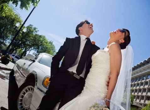 Happy newly wed couple in sunglasses