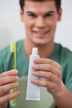 Portrait of dentist holding toothpaste and toothbrush