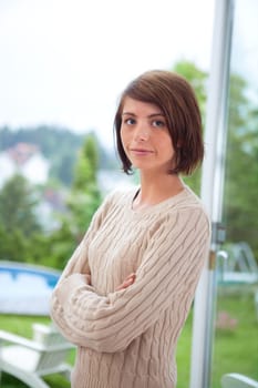 Portrait of beautiful woman standing with hands folded