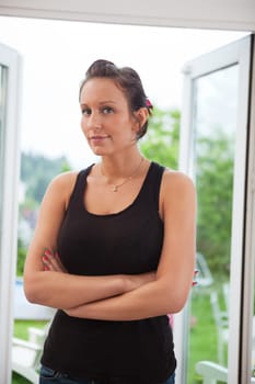 Portrait of attractive young female standing with hands folded
