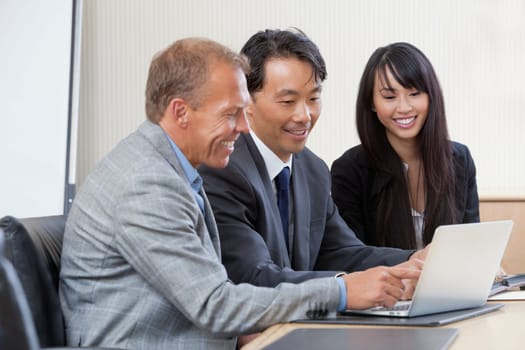 Diverse group of businesspeople working on laptop