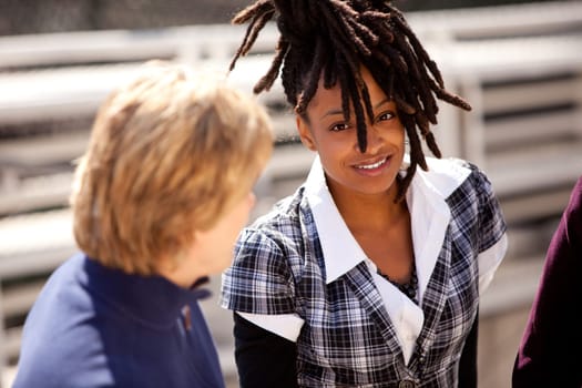 A casual portrait of a beautiful african american talking with friends